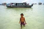 Sama Girl walking from houseboat, Maiga&nbsp;Island