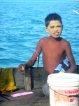 Bajau Laut Boy with Traditional Sunscreen on Houseboat, Semporna,&nbsp;Malaysia